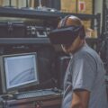 man wearing VR headset turning away from screen