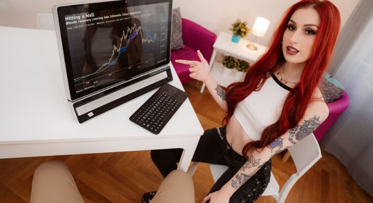 redhead girl looking at crypto currency chart
