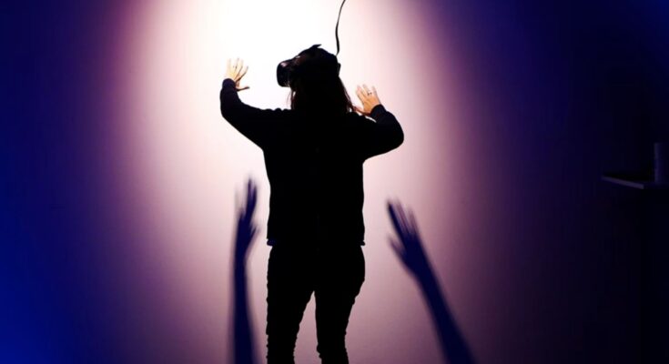 holding back virtual reality image by Stella Jacob