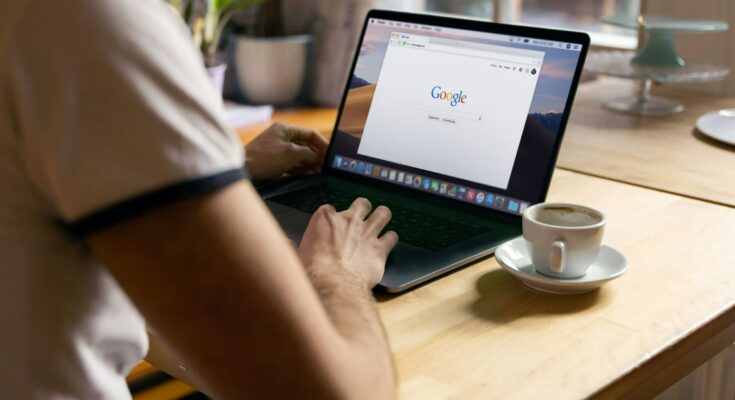 man sitting with laptop searching Google