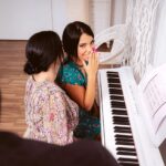Megan Fiore and Sapphire Lapiedra play the piano together